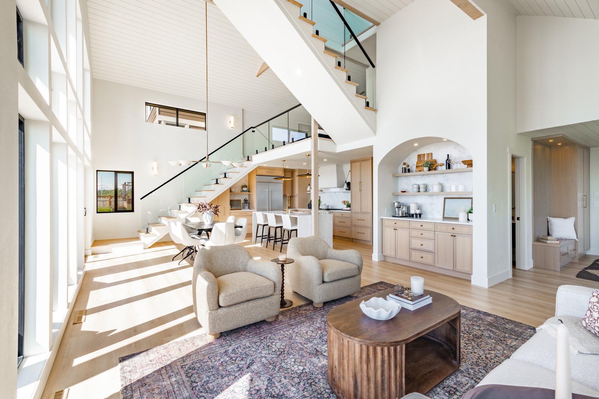 Interior rooms of an ocean front home with floor to ceiling windows vaulted ceiling elegant spacious modern kitchen dining room entry foyer bedroom