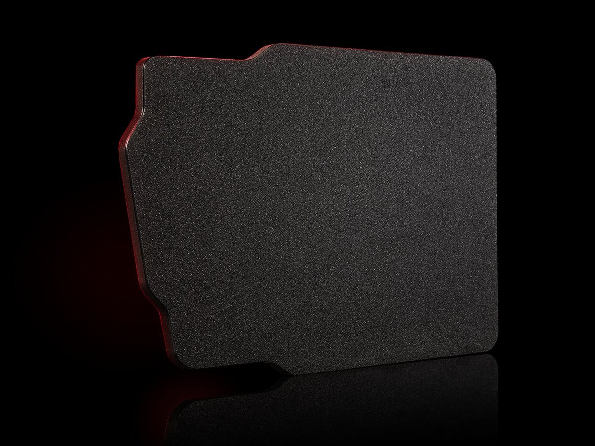 Dark gray gaming mouse pad with red trim and stitched edges on black background