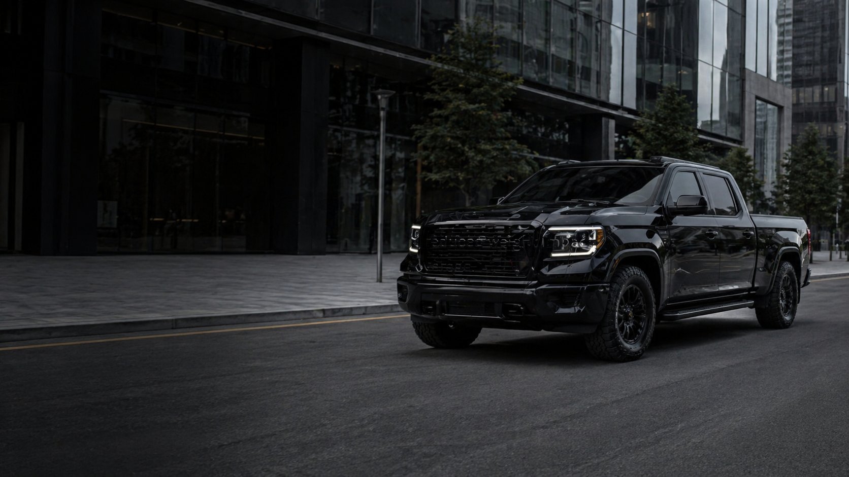 Black pickup truck parked on urban street in front of modern glass buildings and skyscrapers